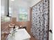 Classic bathroom features a vintage vanity, mosaic tiled walls, and a curtained shower at 113 Overhill Dr, Walterboro, SC 29488