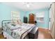 Bright bedroom featuring hardwood floors, light blue walls, and natural light from two windows at 113 Overhill Dr, Walterboro, SC 29488
