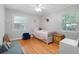Simple, cozy bedroom with wood floors and light grey walls and bright natural light at 113 Overhill Dr, Walterboro, SC 29488