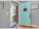 A stylish turquoise front door opens into a light-filled home with beautiful hardwood floors at 113 Overhill Dr, Walterboro, SC 29488
