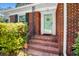 Charming front door with brick steps and black railing, creating an inviting entry at 113 Overhill Dr, Walterboro, SC 29488