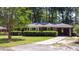 Classic brick home with well-kept landscaping, a covered carport, and a spacious front yard at 113 Overhill Dr, Walterboro, SC 29488
