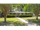 Charming brick home with lush green lawn, manicured hedges, and beautiful mature shade trees at 113 Overhill Dr, Walterboro, SC 29488