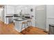 Cozy kitchen with white cabinetry, granite countertops, and breakfast bar seating two at 113 Overhill Dr, Walterboro, SC 29488