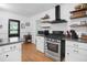 Updated kitchen with stainless steel range, hood, floating shelves, and island at 113 Overhill Dr, Walterboro, SC 29488