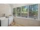Bright laundry room with washer, dryer, and plenty of natural light from large windows overlooking a wooded area at 113 Overhill Dr, Walterboro, SC 29488