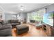 Inviting living room featuring hardwood floors, a comfortable sectional sofa, and a bright window seat at 113 Overhill Dr, Walterboro, SC 29488