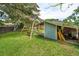 Spacious backyard includes a charming outbuilding, picnic table, swing, and lush greenery at 1160 Landsdowne Dr, Charleston, SC 29412