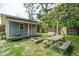 Backyard retreat with a picturesque outbuilding, a cozy fire pit, and a relaxing swing at 1160 Landsdowne Dr, Charleston, SC 29412