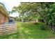 Large, fenced backyard boasting green grass, shade trees, and ample space for recreation at 1160 Landsdowne Dr, Charleston, SC 29412