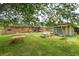 Expansive backyard with mature trees, picnic tables, and a charming swing set for outdoor enjoyment at 1160 Landsdowne Dr, Charleston, SC 29412