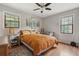 Cozy bedroom features hardwood floors, two windows, and a ceiling fan at 1160 Landsdowne Dr, Charleston, SC 29412