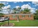 Charming single-story brick home with a well-manicured lawn, attached garage, and inviting curb appeal at 1160 Landsdowne Dr, Charleston, SC 29412