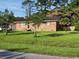 Charming brick home with a well-manicured lawn, mature trees, and a welcoming entrance at 1160 Landsdowne Dr, Charleston, SC 29412