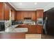Well-equipped kitchen with ample dark wood cabinetry, updated granite countertops, and stainless steel appliances at 1160 Landsdowne Dr, Charleston, SC 29412