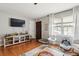 Bright living room with hardwood floors, large window, entertainment center, and ample natural light at 1160 Landsdowne Dr, Charleston, SC 29412