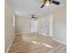 Light-filled bedroom featuring dual ceiling fans and wood-look flooring at 121 Harrison St, Varnville, SC 29944
