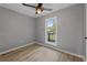 Bright bedroom featuring a modern ceiling fan and window view at 121 Harrison St, Varnville, SC 29944