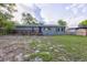 Charming single-story home with a front porch and mature trees at 121 Harrison St, Varnville, SC 29944