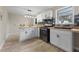 Bright kitchen features white cabinets, butcher block countertops, stainless steel appliances, and luxury vinyl flooring at 121 Harrison St, Varnville, SC 29944