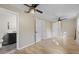 Spacious main bedroom featuring updated flooring, dual ceiling fans, and attached bathroom at 121 Harrison St, Varnville, SC 29944