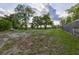 Expansive yard with mature trees and partial fencing at 121 Harrison St, Varnville, SC 29944