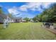 Expansive backyard featuring a lush lawn, patio seating, and charming outdoor structures, perfect for relaxation and entertaining at 127 Travis Hill Rd, Moncks Corner, SC 29461
