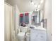 Bright bathroom features a shower with curtain, white vanity, and matching hardware and fixtures at 127 Travis Hill Rd, Moncks Corner, SC 29461