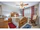 Comfortable bedroom boasts a bed with decorative pillows and matching drapes at 127 Travis Hill Rd, Moncks Corner, SC 29461
