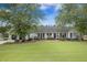 Charming one-story home with well-manicured lawn and inviting front porch at 127 Travis Hill Rd, Moncks Corner, SC 29461