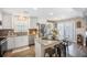 Bright kitchen with stainless steel appliances, island with seating, and hardwood floors at 127 Travis Hill Rd, Moncks Corner, SC 29461