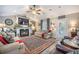 Cozy living room with fireplace, ceiling fan, and comfortable seating area at 127 Travis Hill Rd, Moncks Corner, SC 29461