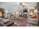 Spacious living room with fireplace, ceiling fan, and seamless flow to kitchen at 127 Travis Hill Rd, Moncks Corner, SC 29461