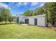 Exterior of large outbuilding with garage door and lawn, great for extra storage at 127 Travis Hill Rd, Moncks Corner, SC 29461