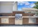 Stainless steel grill in outdoor kitchen with sink and wood-look cabinets, great for entertaining at 127 Travis Hill Rd, Moncks Corner, SC 29461