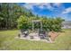 Landscaped outdoor seating area with pergola and four chairs, great for relaxing outside at 127 Travis Hill Rd, Moncks Corner, SC 29461