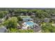 A beautiful aerial view showcasing a pool, tennis courts, and residential homes nestled amongst lush green trees at 1280 Waterfront Dr, Mount Pleasant, SC 29464