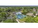 Aerial view of community pool and tennis courts surrounded by trees and neighborhood at 1280 Waterfront Dr, Mount Pleasant, SC 29464