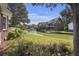 Scenic backyard view featuring a canal, lush greenery, and a charming home with a private dock at 1280 Waterfront Dr, Mount Pleasant, SC 29464