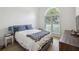 A naturally lit bedroom with plantation shutters and hardwood floors at 1280 Waterfront Dr, Mount Pleasant, SC 29464