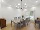 Bright dining room features a modern light fixture, wood floors, and large window with plantation shutters at 1280 Waterfront Dr, Mount Pleasant, SC 29464
