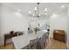 Elegant dining room boasts a stylish chandelier, light wood floors, and seating for six at 1280 Waterfront Dr, Mount Pleasant, SC 29464