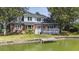 Charming two-story brick home with a white deck and a private dock on the water at 1280 Waterfront Dr, Mount Pleasant, SC 29464