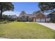 Beautiful brick home with a well-manicured lawn, a two-car garage, and mature trees at 1280 Waterfront Dr, Mount Pleasant, SC 29464