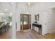 Elegant foyer with hardwood floors, a decorative mirror, and a stylish light fixture at 1280 Waterfront Dr, Mount Pleasant, SC 29464