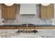 Modern kitchen featuring marble countertops, a tile backsplash, and wood cabinets at 1280 Waterfront Dr, Mount Pleasant, SC 29464