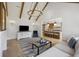 Spacious living room with vaulted ceilings, wood beams, and seamless open-concept design to kitchen at 1280 Waterfront Dr, Mount Pleasant, SC 29464