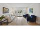 Comfortable living room with neutral sofa, blue chairs, French doors and wood floors at 1280 Waterfront Dr, Mount Pleasant, SC 29464