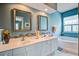 Bathroom featuring dual sinks, white cabinetry, decorative mirrors, and a tiled backsplash at 1335 Hopton Cir # 1335, Mount Pleasant, SC 29466