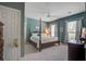 This primary bedroom features a wooden four-poster bed, ceiling fan, and natural light at 1335 Hopton Cir # 1335, Mount Pleasant, SC 29466